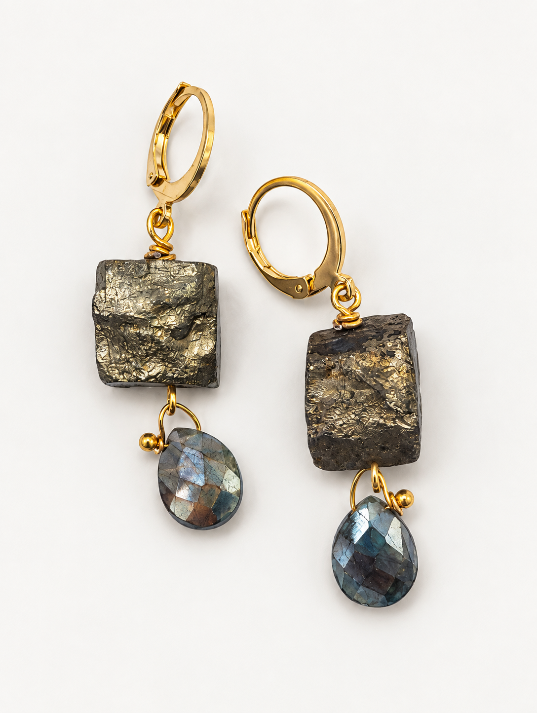 Gold-filled pyrite earrings with faceted labradorite gemstone drops on a white background