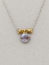 Silver coin pearl pendant necklace featuring a gold-toned bead detail