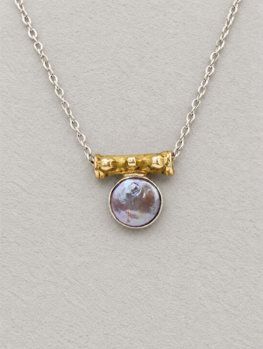 Silver coin pearl pendant necklace featuring a gold-toned bead detail