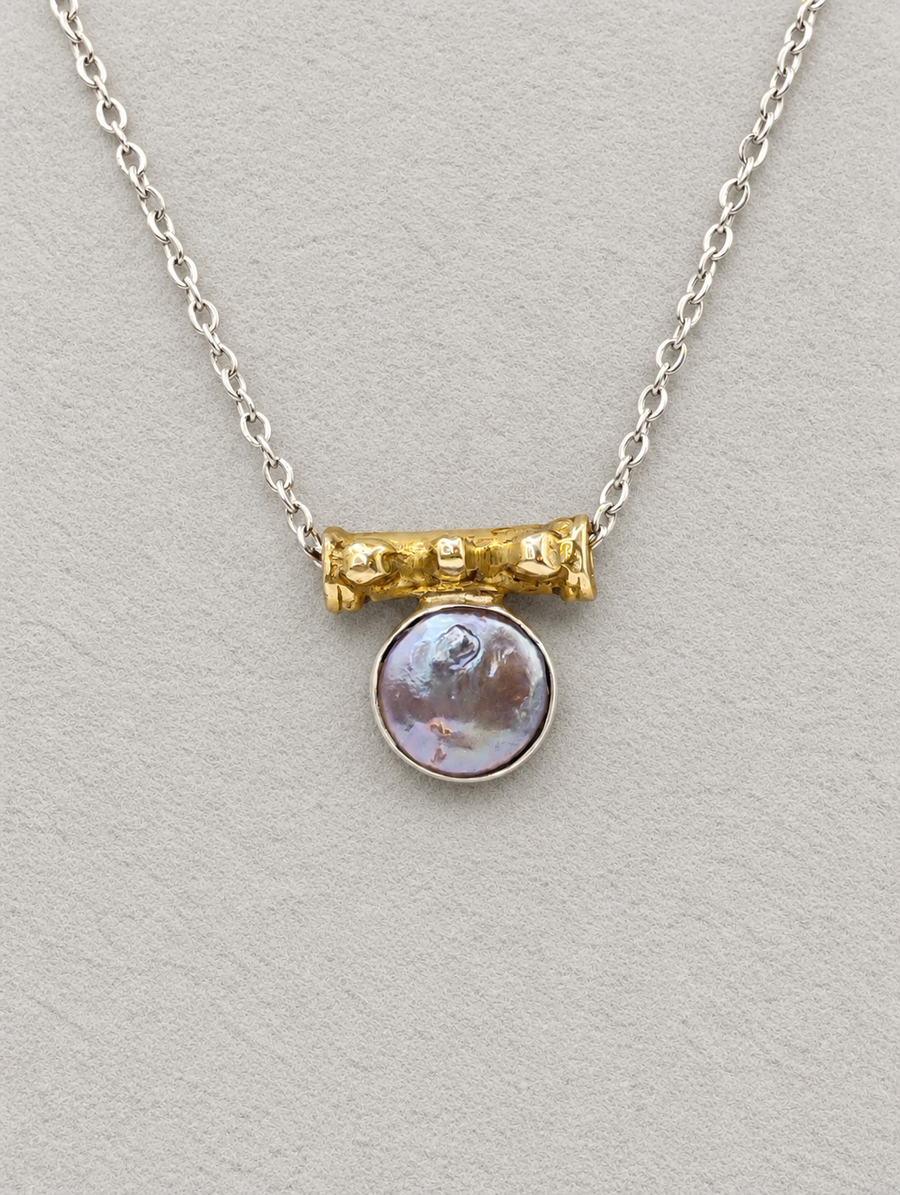 Silver coin pearl pendant necklace featuring a gold-toned bead detail