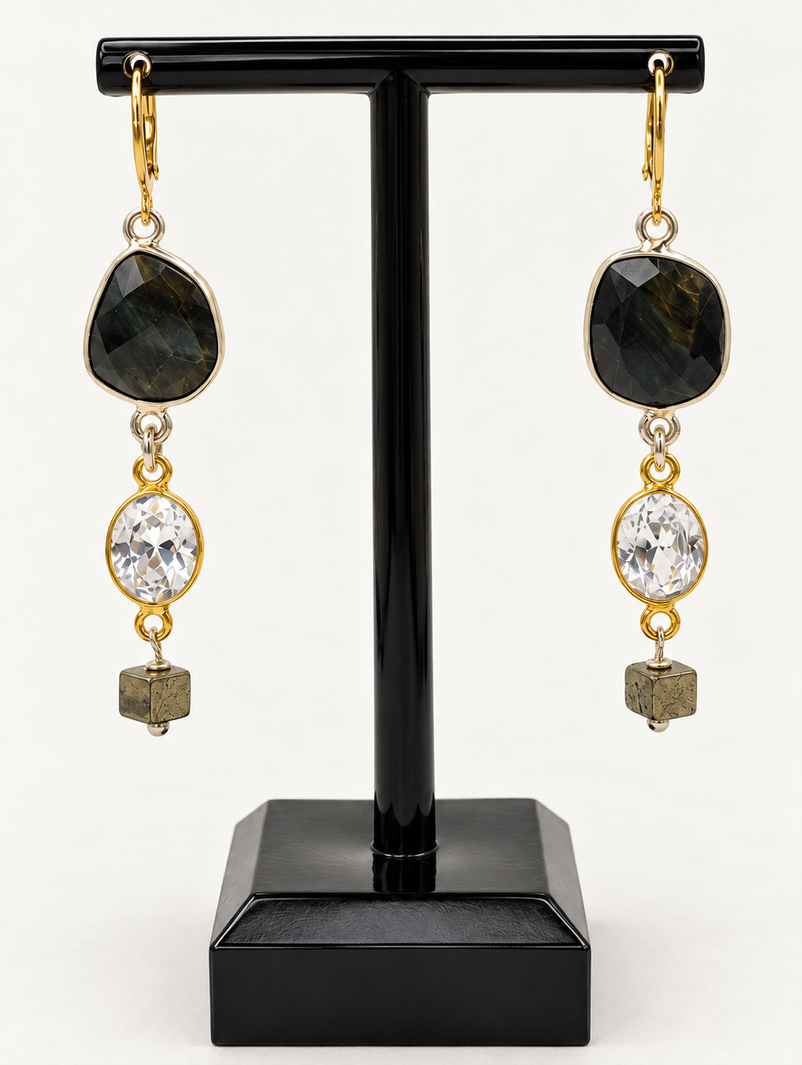 Agate pyrite drop earrings with dark round agate stones and dangling pyrite cube accents on a display stand