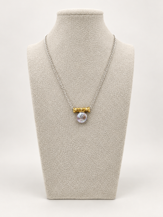 Silver coin pearl necklace displayed on a jewelry bust